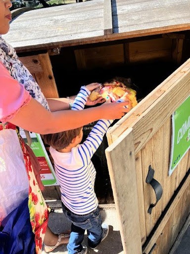 FAA First grade student taking unwanted leftovers to be composted